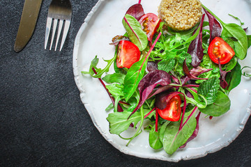Healthy quinoa salad leaves mix (mix micro greens, cucumber, tomato, other ingredients) menu concept background. top view. copy space for text