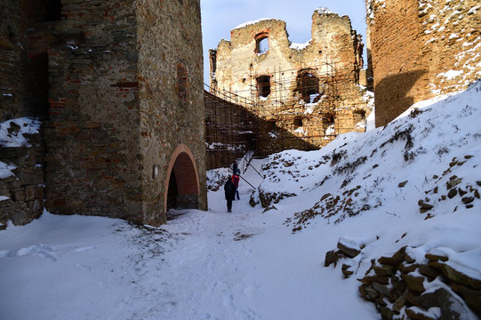 Family trip on castle ruins on the snow in winter Zborov Slovakia 