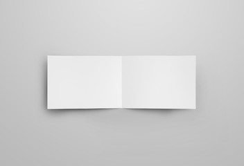 Fototapeta premium Horizontal paper open bifold, for design presentation. Mockup of white blank booklet isolated on gray background.