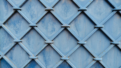blue forged geometric pattern on a metal surface