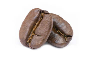 Two roasted coffee beans isolated on white background.