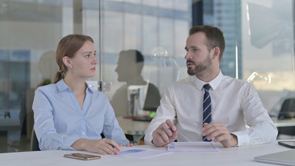 The Business people having Serious Arguments on Documents
