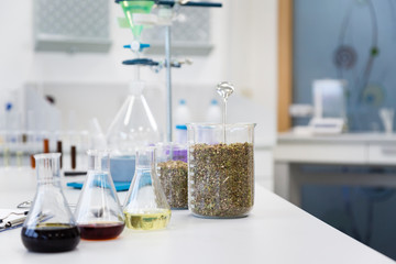 Hemp seeds in glass on laboratory desk