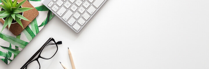 White home office desk. Copy space. Office stuff. Keyboard, succulent, gray cup with coffee. Place...