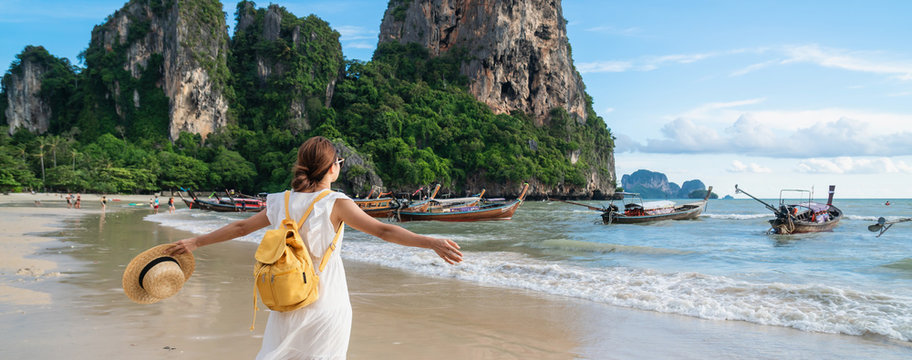 Young woman traveler enjoying a summer vacation at tropical sand beach in Krabi, Thailand