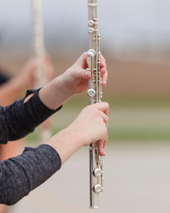 hands of a flute player during a marching band rehearsal