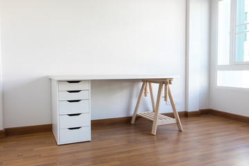 working space with wood table and chair in white empty room. Interior space.