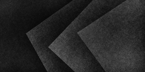 Black abstract background with texture, geometric black and white triangles and square shapes in layered abstract pattern, modern textured design