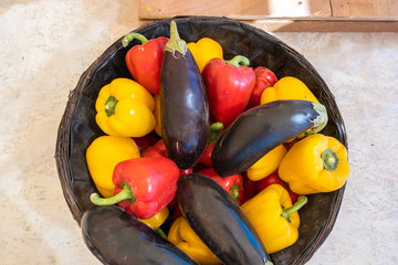 Assortment of organic vegetables in the wooden bowl at an agricultural exhibition