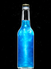 Blue carbonated alcoholic drink in a glass bottle saturated with food-grade pearlescent suspension