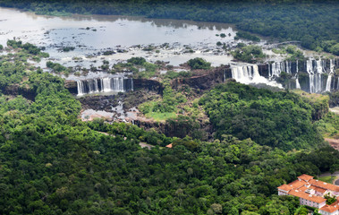 Fototapeta na wymiar roaring waterfalls in the wild jungle from a helicopter