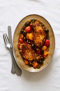 Roasted white fish with cherry tomatoes, lemon rind and olives