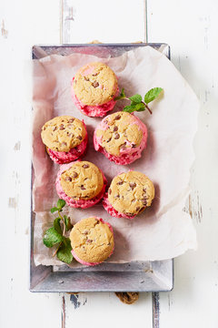 Top view image of raspberry ice cream sandwiches with chocolate chip cookies