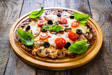 Margherita pizza on wooden background