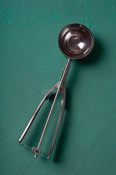 Ice cream scoop on dark green background