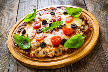 Margherita pizza on wooden background