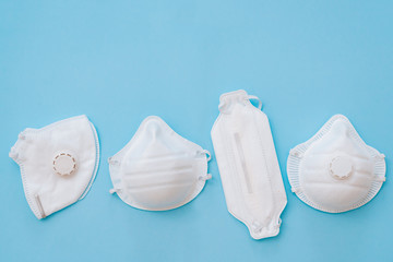 White variety mask respirator on a blue background. The face mask protects against environmental...