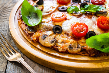 Margherita pizza on wooden background