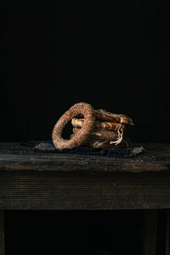 German Bread Pretzel and Bagel Breakfast on a wooden table. Black Background.