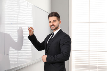 Fototapeta premium Professional business trainer near whiteboard in office