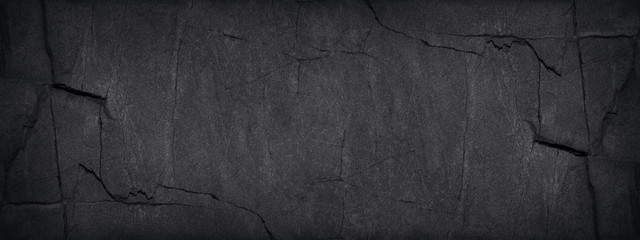 Black grunge background. Dark gray stone background with copy space. Black grunge banner with rock...