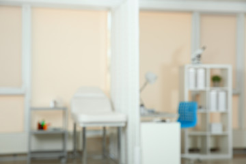 Blurred view of doctor's office interior with couch