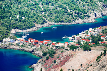 Aerial view panorama of colorful Asos village at Kefalonia island. Greece. Popular destination on Ionian Sea for vacation. Mediterranean port for traveling by yacht and honeymoon paradise. 