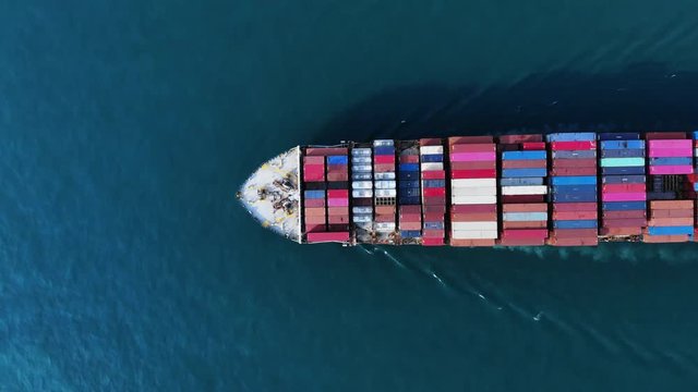 Aerial top view of cargo container ship working. Container bulk or Cargo Ship Large vessel running to yard port concept freight shipping ship.  forwarder mast. import export