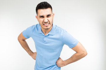 brunette man in a blue t-shirt is angry on a white isolated background