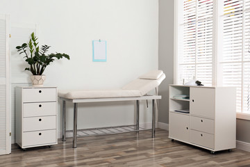 Modern medical office interior with examination table