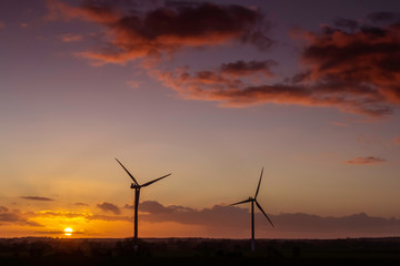 Fototapeta na wymiar two windmills at sunset landscape view