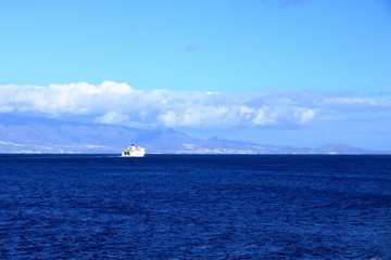 Fototapeta premium Teide volcano in Tenerife seen a boat in the ocean. Canary islands, Spain