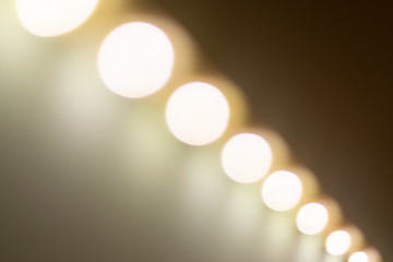Blurry warm lights bokeh seen from a diagonal perspective