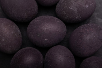 Close-up dark easter eggs. Colored with wine.
