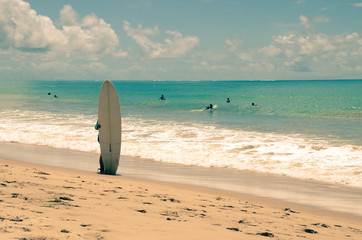 Fototapeta na wymiar Surfer standing on the beach