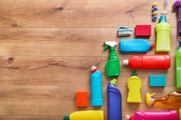 Many cleaning products on wood background. Top view