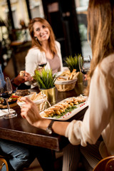 Two young women at a dinner  in a restaurant