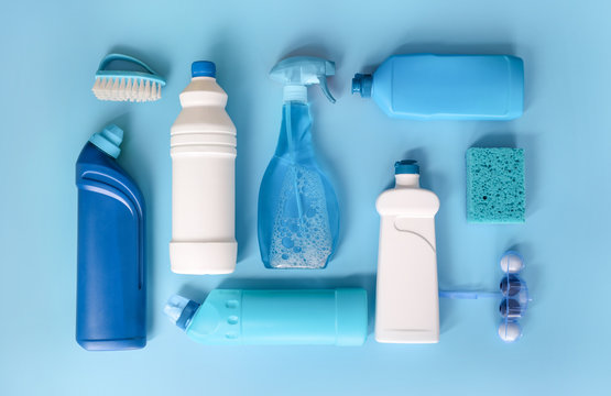 Blue cleaning products on blue background. Top view