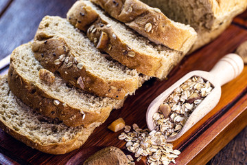 vegan bread, without animal products, made from Brazilian nuts, oats and flaxseed. Concept of healthy life and diet. Sliced ​​bread on rustic wooden background.