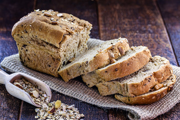 homemade vegan bread with nuts, chestnuts, oats and flaxseed. Healthy life and diet concept.