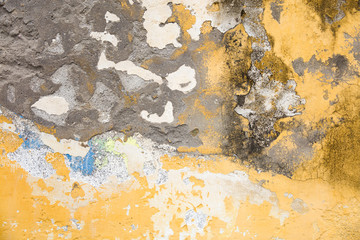 Old grunge decayed yellow textured wall