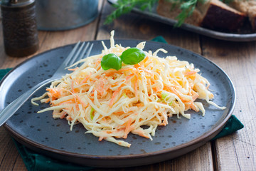 Cole slow salad with white cabbage and carrots, selective focus