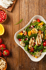 Traditional Greek salad with grilled Halloumi cheese with basil. Top view. Flat lay.