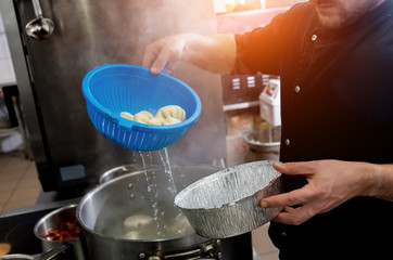 Chef coocking georgian khinkali or japanese wonton. Traditional meal