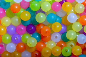 Macro photography of some colorful beads of different shape used for manufacturing jewerly and accesories.