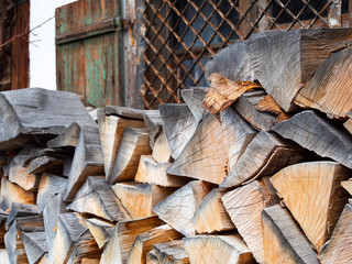 Close up of the firewood with the  heritage wood house in background.