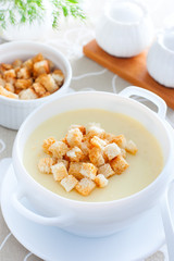 Mashed potato soup with croutons of white bread, selective focus