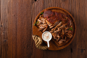 Pulled pork on a wooden board. Top view.
