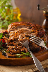 Pulled pork on a wooden board.