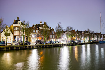 Fototapeta na wymiar Harlingen, Netherlands - January 09, 2020. Traditional dutch houses at night